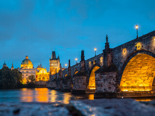 Naklejka premium View of Charles Bridge in Prague in the night, Czech Republic. popular tourist attraction. Travel and sights of city breaks. landmarks, travel guide and postcard.