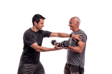 An elderly European man, with a personal trainer, trains, lifting weights, on a white background. - obrazy, fototapety, plakaty