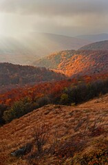 The rays of the sun breaking behind the clouds over Bukowe Berdo, Bieszczady Mountains