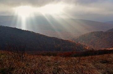 The rays of the sun breaking behind the clouds over Bukowe Berdo, Bieszczady Mountains