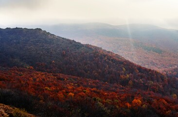 The rays of the sun breaking behind the clouds over Bukowe Berdo, Bieszczady Mountains