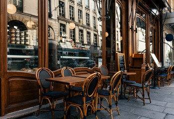 Typical view of the Parisian street with tables with tables of cafe in Paris, France. Architecture...