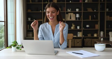 Euphoric woman freelancer sit by laptop scream great yes feel lucky motivated getting email message about reward for good job. Excited teen female student amazed with achieving success in passing exam