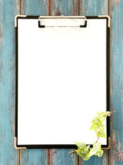 クリップボードに挟んだ白い用紙_青色木板背景