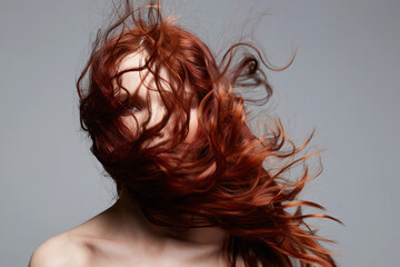 Naklejka premium beautiful young woman with curly red hair