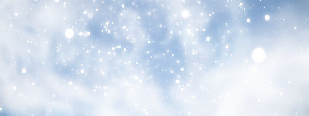 Fototapeta premium blue snowfall bokeh background, abstract snowflake background on blurred abstract blue