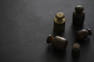 Tiny weights on vintage balance scales. Detail of Ancient old scale, Vintage old brass weight scale.