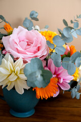 Obraz na płótnie Canvas Autumnal flowers bouquet in a vase. Beautiful, colorful dahlia, roses and eucalyptus plant.