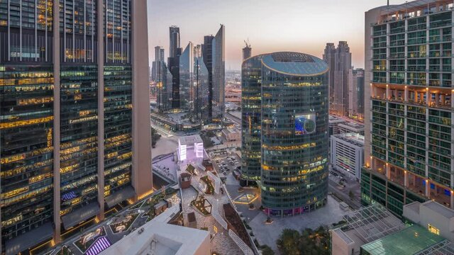 Dubai international financial center skyscrapers aerial day to night timelapse.