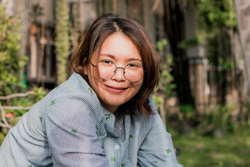 Close up of young pretty Asian woman in the garden.