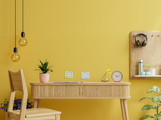 Office desk interior with mockup yellow wall.