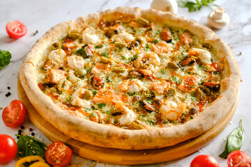 Appetizing, fresh pizza is on the table. Food from an Italian restaurant. Cooking pizza. Pizza ingredients.