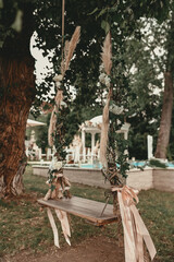 Beautifully floral swing in the yard. Autumn wedding ambiance