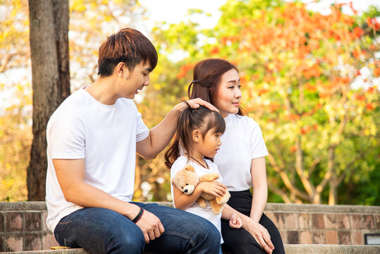 Photo of young happy Asian family in garden. Asian family and happy family concept