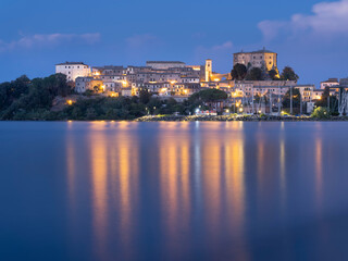 Fototapeta na wymiar night lights of city Capodimonte on lake Bolsena in Italy