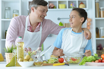 Close up portrait of father and son cooking