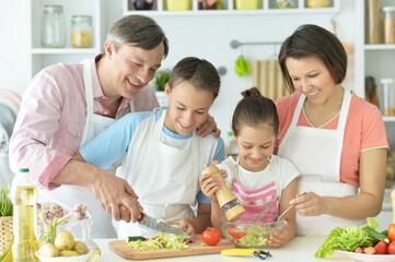 Obraz na płótnie Canvas Close up portrait of cute family cooking