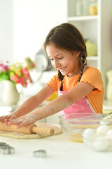 Portrait of a young girl baking in the kitchen