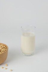 Soy vegetable milk in the glass and soybeans. Homemade. Isolated and white background