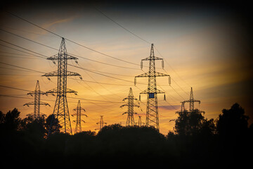Fototapeta premium High voltage electric industrial gear against the backdrop of a picturesque sunset