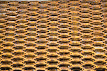 Background of a metal lattice of xiphoid shape with traces of rust. Construction production backgrounds.