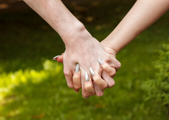 man and woman hold hands. hands closeup