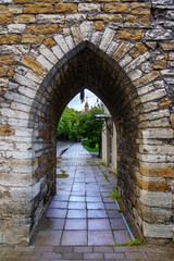 Fototapeta na wymiar Entrance in the medieval wall with stone arch in Tallinn Estonia.