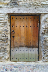 Very old wooden door with lock and metal fittings.