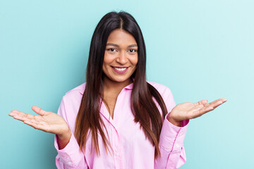 Young Venezuelan woman isolated on blue background showing a welcome expression.