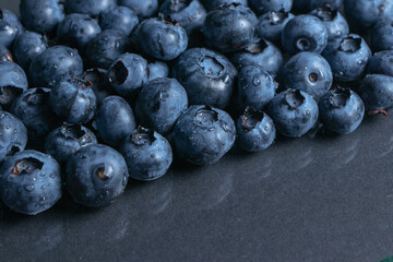 Blueberries background. Blueberry border design. Ripe and juicy fresh picked bilberries close up. Copyspace for your text