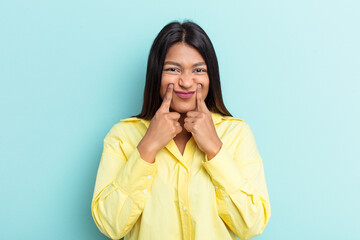 Young Venezuelan woman isolated on blue background doubting between two options.