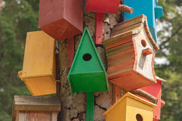Collection of colorful wooden birdhouses.