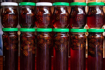 Pine cones in honey. Glass jars of pine cone jam