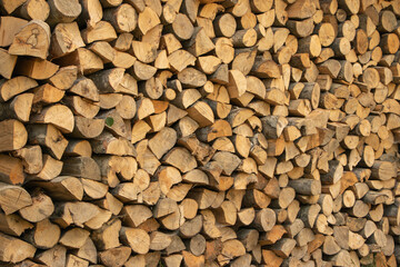 Wall firewood, Background of dry chopped firewood logs in a pile