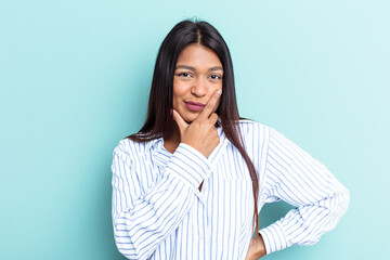 Obraz premium Young Venezuelan woman isolated on blue background contemplating, planning a strategy, thinking about the way of a business.