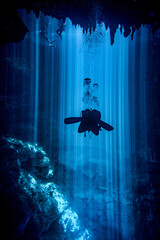 scuba diver silhouette in underater cave
