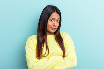 Obraz premium Young Venezuelan woman isolated on blue background unhappy looking in camera with sarcastic expression.