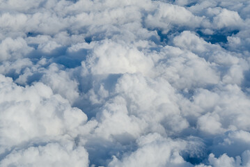 View of the sky above the clouds. blue sky high view from airplane window clouds shapes. sky-clouds background. Above the cloud