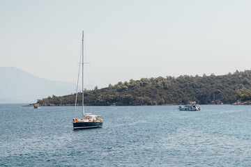 Floating boats in the sea in Turkey with mountains in the background