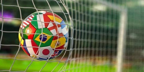 Fotobehang Football ball with flags of world countries in the net of goal of football stadium. World cup championship 2022. © Maksym Yemelyanov