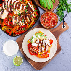 Chicken Fajitas with bell pepper, onion, salsa Asada, avocado and sour cream on soft tortilla, square
