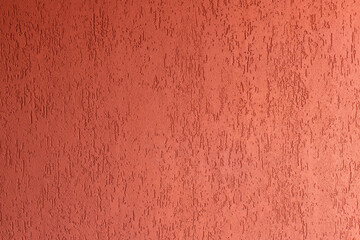 Surface of wall with decorative red plaster. house facade with spatula technique structure. selective focus