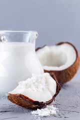 Vegan powdered milk made from coconut, powder and dissolved with water in glass jar