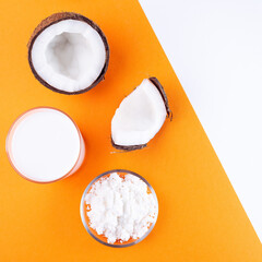 Coconut milk in powder and dissolved with water in a glass on an orange