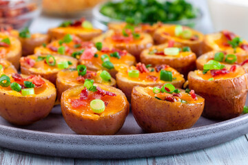 Red skinned loaded potatoes with crispy bacon, scallions and sharp cheddar cheese