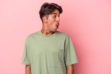 Young mixed race man isolated on white background being shocked because of something she has seen.