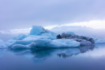 Fototapeta na wymiar out of this world blue icebergs floating in Glacier Lagoon in Iceland along route 1.