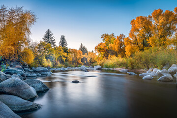 fall color smooth water river reflection during blue hour 