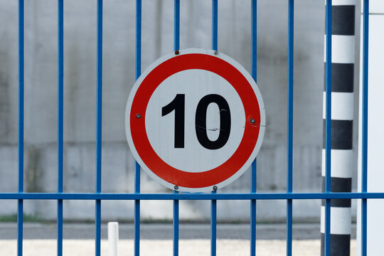 white circle road sign with red border and number ten. speed limit 10 kilometers per hour