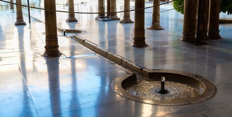 The water is flowing from the fountains to the marble ground in the famous arab mansion of Granada...